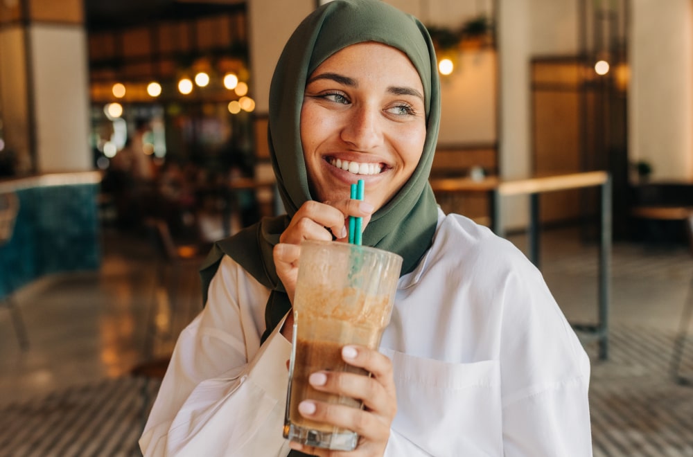 a happy woman is enjoying her drink