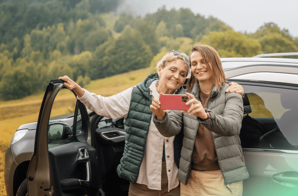 two happy woman are taking selfies