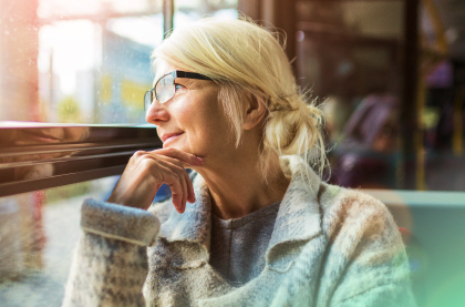 A happy lady sitting by the window